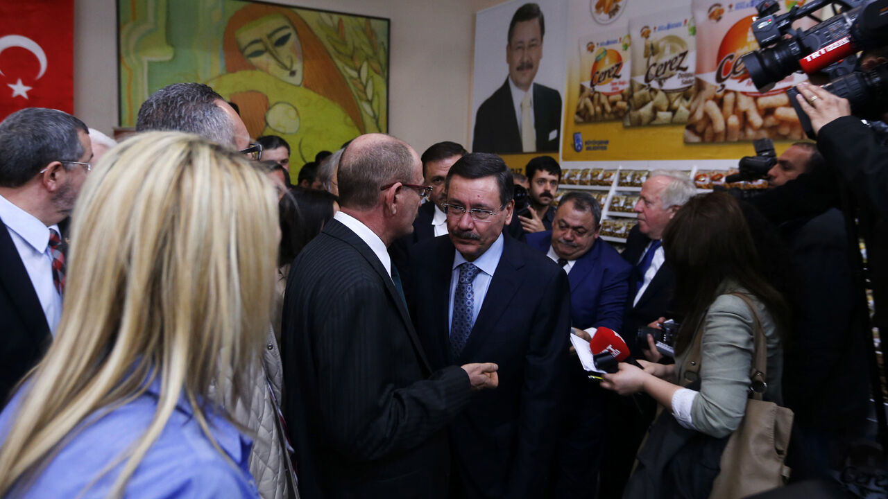 TURKEY-ELECTIONS/ANKARA Turkey's ruling AK Party (AKP) mayoral candidate and current Ankara Mayor Melih Gokcek (C) attends an event as part of his election campaign in Ankara March 18, 2014. The local elections will be the first concrete test of Prime Minister Tayyip Erdogan's popularity since anti-government protests rocked major cities last summer and the corruption scandal erupted in mid-December. The race for Ankara is set to be among the closest , with current mayor Melih Gokcek, an argumentative character known for fiery co