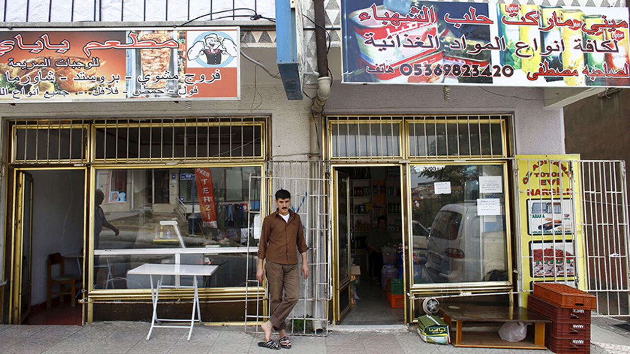 EUROPE-MIGRANTS/TURKEY A Syrian man who had fled the war in his homeland stands outside shops run by Syrians in a low-income neighborhood of Ankara, Turkey, September 29, 2015. Nearly five years after the conflict in Syria began, Turkey has shouldered the brunt of the humanitarian burden, sheltering at least 2.3 million Syrians, the largest refugee population in the world. But tensions are simmering between Turk and Syrians as it struggles to integrate a population that does not speak the language and is largely prevented from wo
