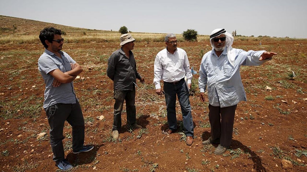 ISRAEL-RIGHTS/ B'Tselem field researcher Iyad Hadad (2nd R) listens to a testimony from a Palestinian farmer, who said his land was damaged in an attack by Israeli settlers, in the West Bank village of Turmus Aya near Ramallah June 8, 2015. B'Tselem is an Israeli NGO that has long been a bane of the government, tirelessly flagging human rights abuses by Israel's military in the Palestinian territories. Set up by a group of academics, lawyers, journalists and politicians more than 25 years ago, the organisation - whose nam