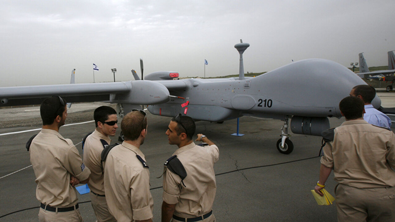ISRAEL/ Israeli soldiers look at an IAI Eitan, also known as the Heron TP, surveillance unmanned air vehicle (UAV) on display at Tel Nof Air Force Base near Tel Aviv February 21, 2010. An Israeli air force officer said the Israeli-made drone is larger than any other drone and can fly at higher altitudes, while carrying more weight including advanced technological systems. The officer said the drone's main advantage was its longer flying time, estimated at 20 hours. REUTERS/Gil Cohen Magen (ISRAEL - Tags: TRANSPORT