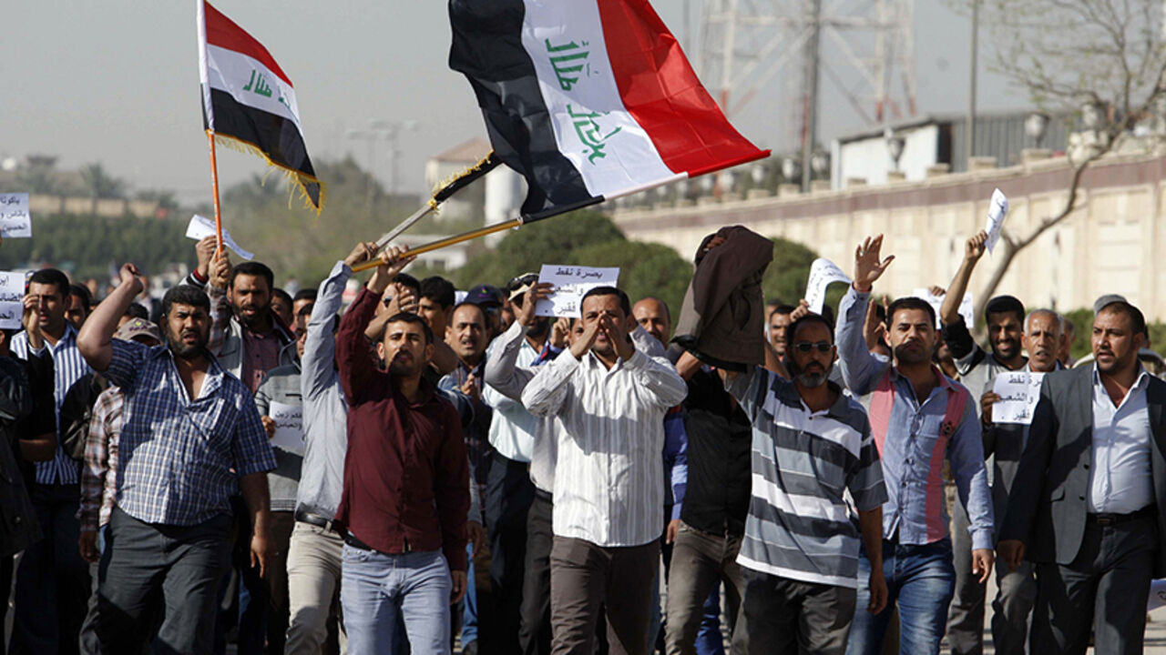 IRAQ/ Staff from the South Oil Company (SOC) demonstrate to demand higher salaries and better benefits, in Basra, 420 km (261 miles) southeast of Baghdad, February 19, 2013. REUTERS/Atef Hassan (IRAQ - Tags: CIVIL UNREST ENERGY) - RTR3DZET