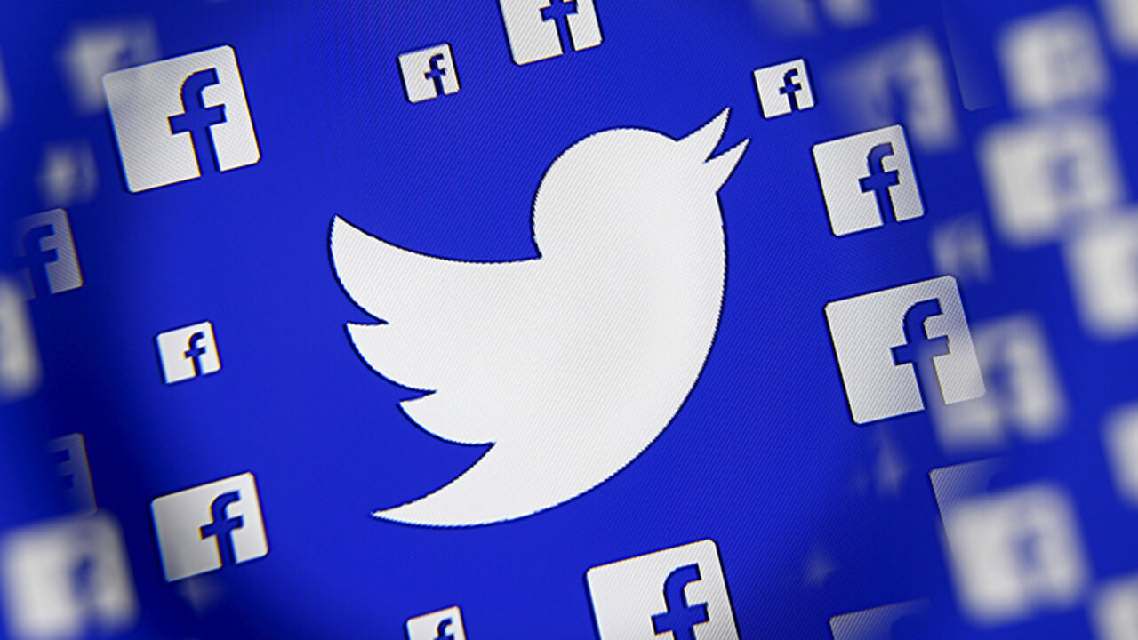 TWITTER-FACEBOOK/ Logo of the Twitter and Facebook are seen through magnifier on display in this illustration taken in Sarajevo, Bosnia and Herzegovina, December 16, 2015. Broker's survey shows Twitter losing share to faster growing competitors such as Facebook's Instagram and Snapchat, despite co's multiple product and partnership launches this year, analysts write in note. REUTERS/Dado Ruvic - RTX1Z12A