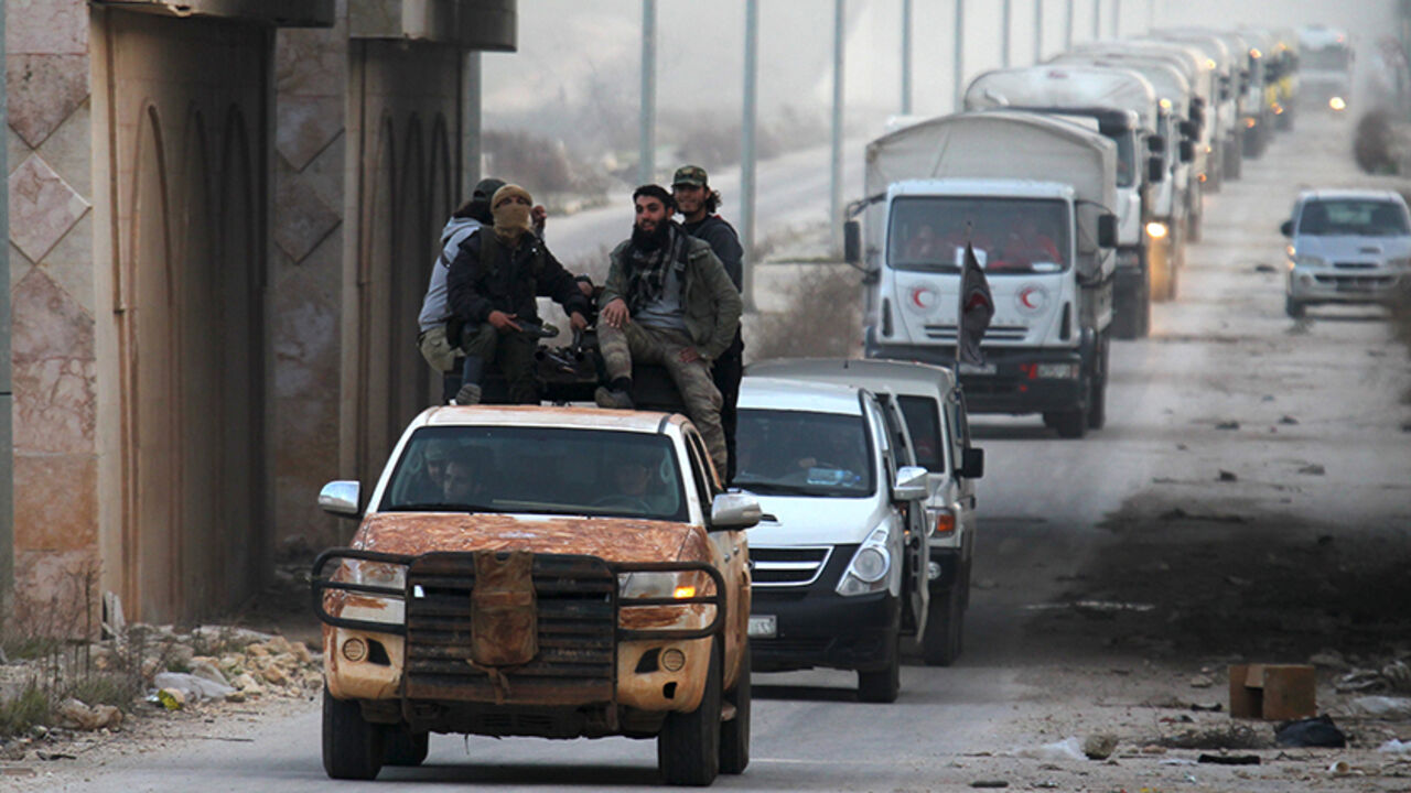 MIDEAST-CRISIS/SYRIA-AID Rebel fighters escort a Syrian Arab Red Crescent aid convoy heading towards the villages of al-Foua and Kefraya in Idlib province, Syria February 17, 2016. REUTERS/Ammar Abdullah TPX IMAGES OF THE DAY - RTX27EF4