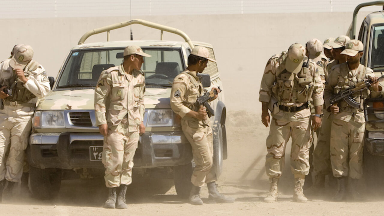 DRUGS-UN/IRAN Iranian anti-narcotics policemen protect themselves from blowing sand at a police barracks on the border with Afghanistan near Zabol, 1,605 kilometers (1,003 miles) southeast of Tehran May 20, 2009. Iran, which shares a 900-km (560-mile) border with Afghanistan, is a conduit for smuggling drugs to the West from its insurgency-ridden neighbour. REUTERS/Caren Firouz (IRAN CRIME LAW POLITICS SOCIETY) - RTXKMQR
