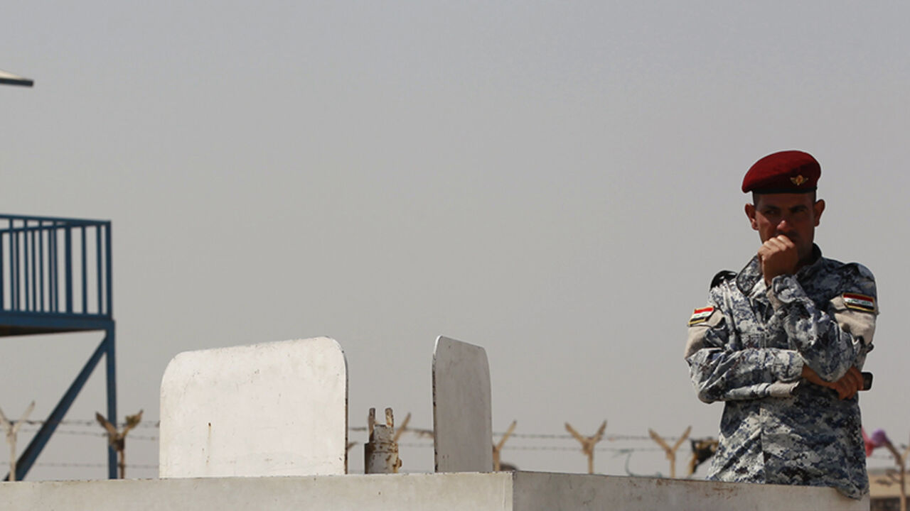 IRAQ A policeman looks on outside a prison in eastern Baghdad September 19, 2011. Six inmates were killed and 27 others injured after a fire broke out early on Monday at a prison in eastern Baghdad, police and hospital sources said. The reason of the fire was unknown. An Interior Ministry source said three inmates were killed and 30 wounded in the fire. REUTERS/Thaier al-Sudani (IRAQ - Tags: CIVIL UNREST CRIME LAW DISASTER) - RTR2RJN5