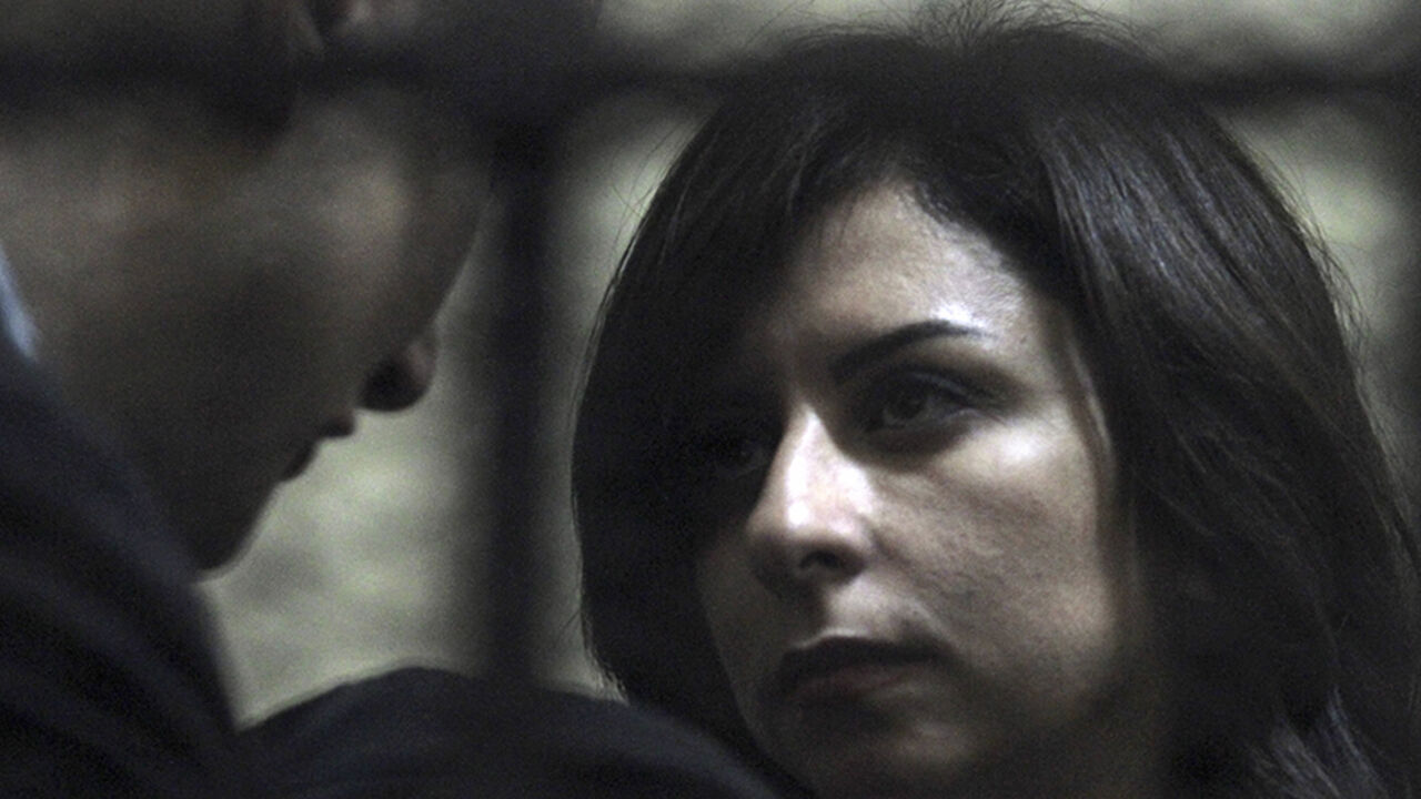 EGYPT-USA/NGO One of the 14 Egyptian activists accused of working for unlicensed non-governmental organizations (NGOs) and receiving illegal foreign funds, speaks with American Robert Becker (L) of the National Democratic Institute (NDI) in a cage during their trial in Cairo March 8, 2012. An Egyptian judge said on Thursday he was delaying until April 10 the trial of civil society activists including 16 Americans accused of receiving illegal foreign funds and pursuing their pro-democracy activities without a licence. REU