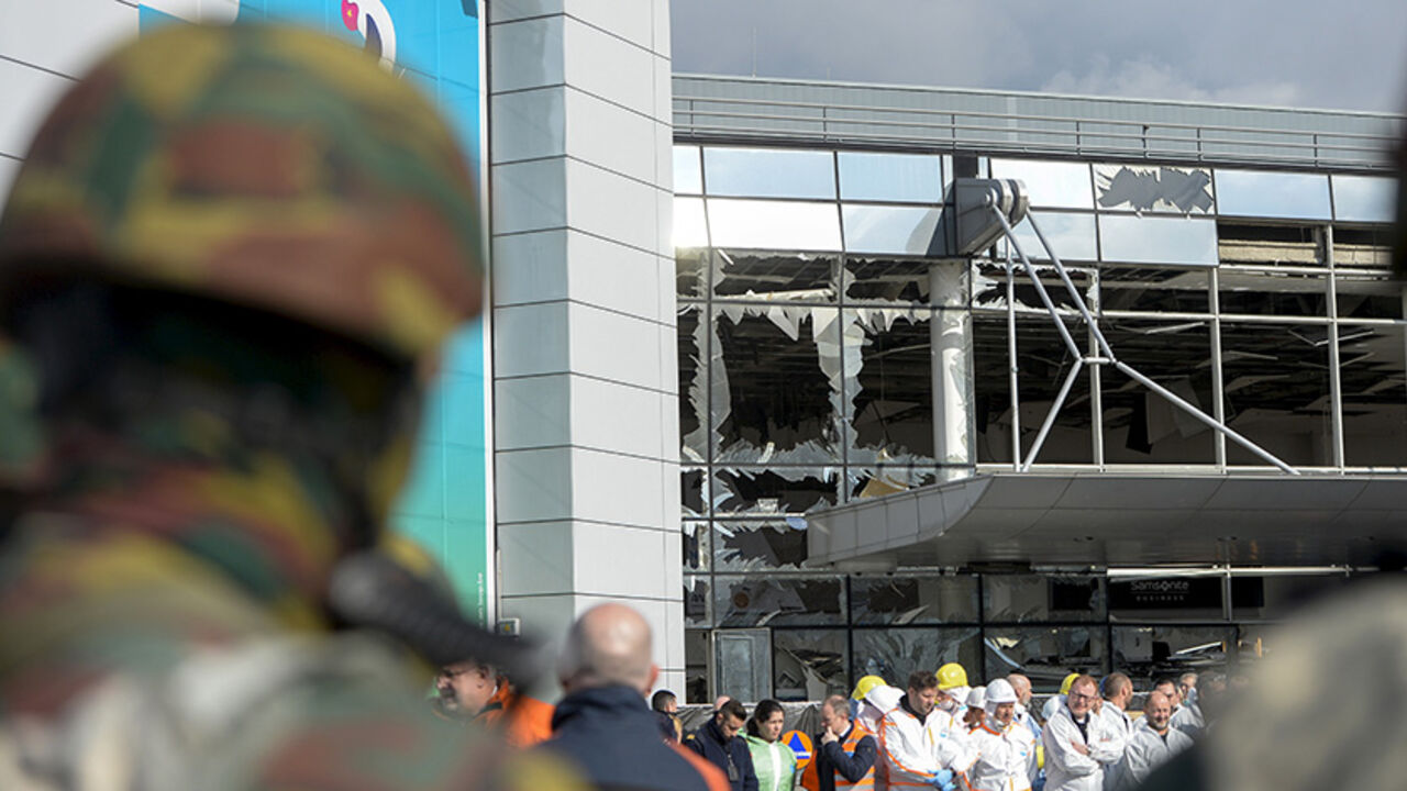 Windows of the terminal at Brussels national airport are seen broken during a ceremony following bomb attacks in Brussels metro and Belgium's National airport of Zaventem, Belgium, March 23, 2016. REUTERS/Frederic Sierakowski/Pool - RTSBXL3