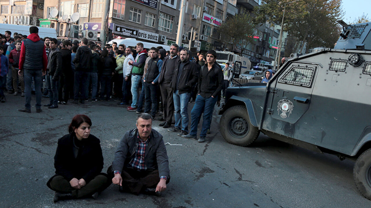 TURKEY-KURDS/CLASHES Sibel Yigitalp (L), a parliamentarian from the the pro-Kurdish Peoples' Democratic Party (HDP), and Abdullah Akengin, a former local mayor, holds a sit-in protest against the curfew in Sur district, in the southeastern city of Diyarbakir, Turkey, December 18, 2015. REUTERS/Sertac Kayar - RTX1ZABH