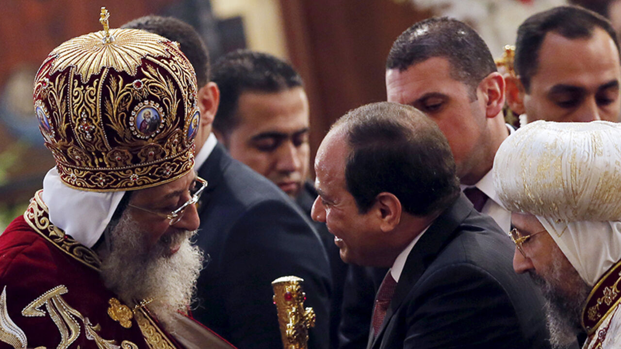 CHRISTMAS-SEASON/EGYPT COPTIC Egypt's President Abdel Fattah al-Sisi (R) greets Pope Tawadros II (L), the 118th Pope of the Coptic Orthodox Church of Alexandria and Patriarch of the See of St. Mark Cathedral, during Egypt's Coptic Christmas eve mass in Cairo, Egypt, January 6, 2016. REUTERS/Amr Abdallah Dalsh - RTX21BTB