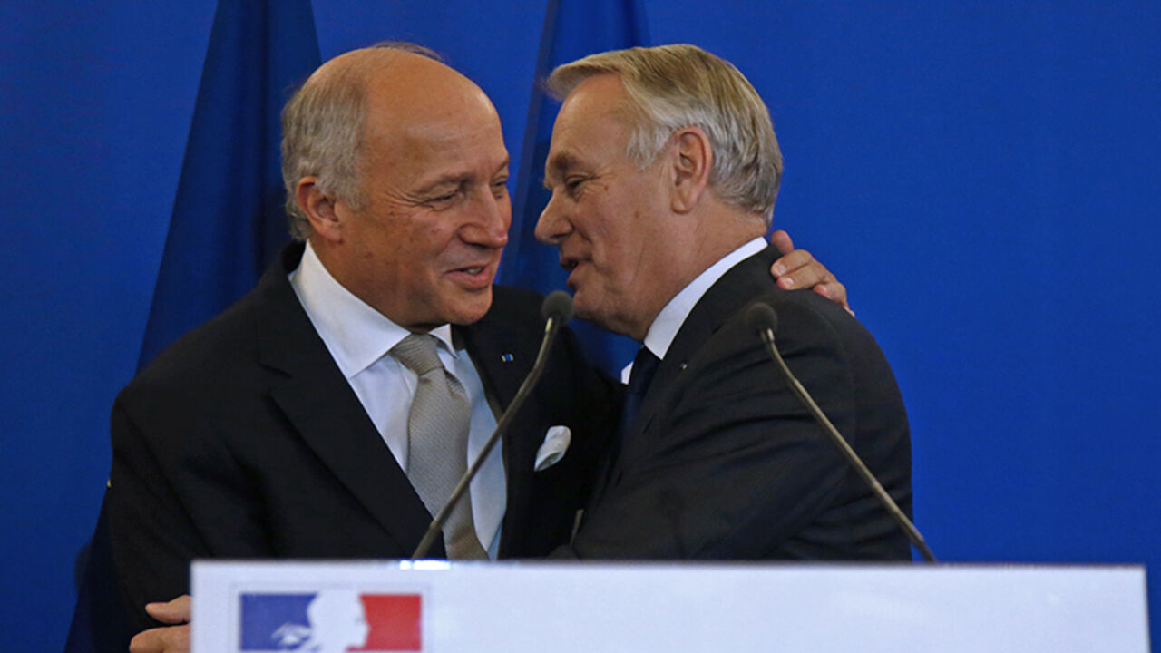 FRANCE-POLITICS/RESHUFFLE Outgoing French Foreign Minister Laurent Fabius (L) embraces newly-appointed Foreign Minister Jean-Marc Ayrault during the official handover ceremony at the Quai d'Orsay, Ministry of Foreign Affairs, in Paris, France, February 12, 2016. REUTERS/Jacky Naegelen - RTX26NQI