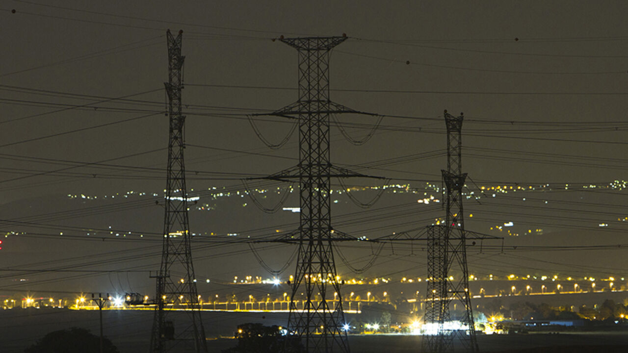 ISRAEL-ELECTRIC/ Electricity pylons and power transmission lines are seen at night near Kibbutz Negba in southern Israel May 17, 2012. Israel Electric Corp (IEC), which is responsible for nearly every aspect of electricity from running power plants to connecting households, simply cannot keep up with growing demand.The state-owned utility just lost natural gas supplies from neighbouring Egypt and fuel costs are soaring. Reserves are low and capacity insufficient and the government, under pressure from massive cost-of-living