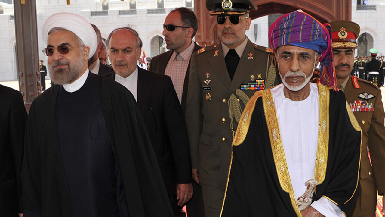 OMAN/ Oman's Sultan Qaboos bin Said (R) walks with Iran's President Hassan Rouhani upon Rouhani's arrival in Muscat March 12, 2014. REUTERS/Sultan Al Hasani (OMAN - Tags: POLITICS ROYALS) - RTR3GQAH