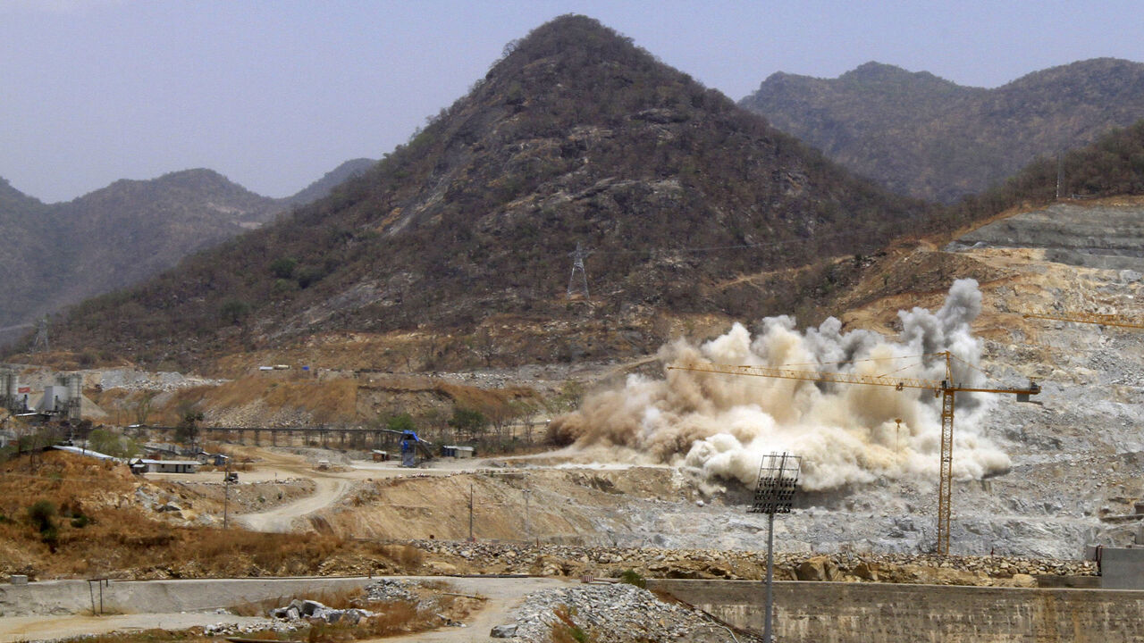 A cloud of dust rises from a dynamite blast, as part of construction work, at Ethiopia's Grand Renaissance Dam during a media tour along the river Nile in Benishangul Gumuz Region, Guba Woreda, in Ethiopia March 31, 2015. According to a government official, the dam has hit the 41 percent completion mark. Picture taken March 31, 2015. REUTER/Tiksa Negeri  - RTR4VQ69