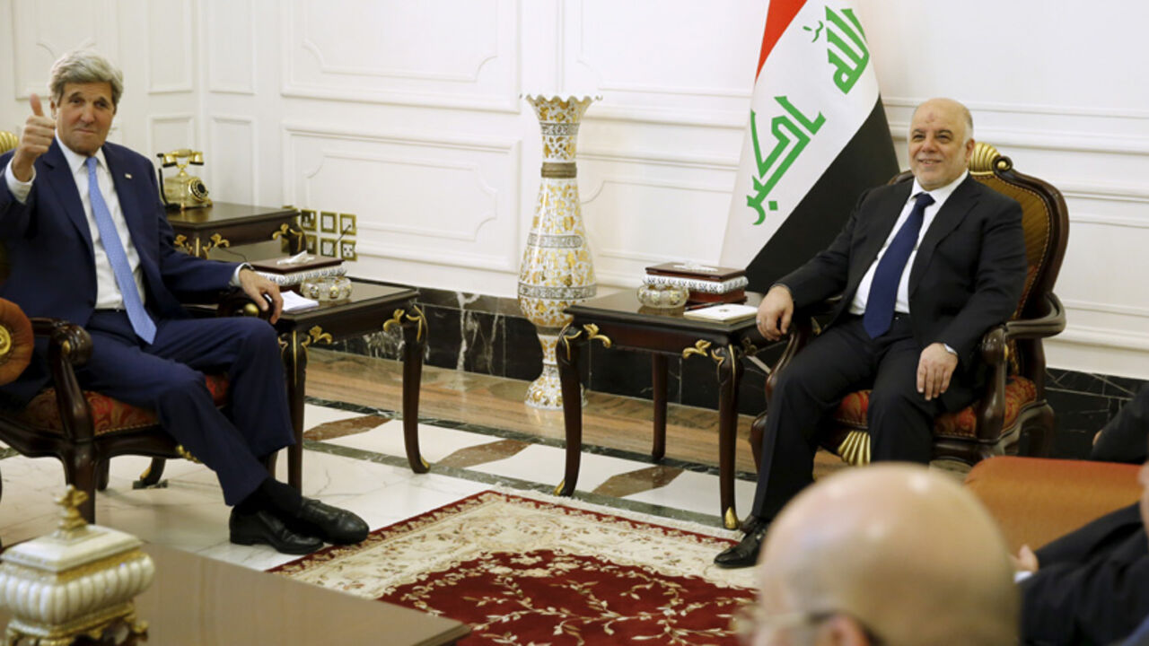 MIDEAST-CRISIS/IRAQ-USA U.S. Secretary of State John Kerry (L) gives a thumbs-up as Iraq's Prime Minister Haider al-Abadi (R) welcomes him at the prime minister's palace in Baghdad April 8, 2016. REUTERS/Jonathan Ernst - RTSE5GF