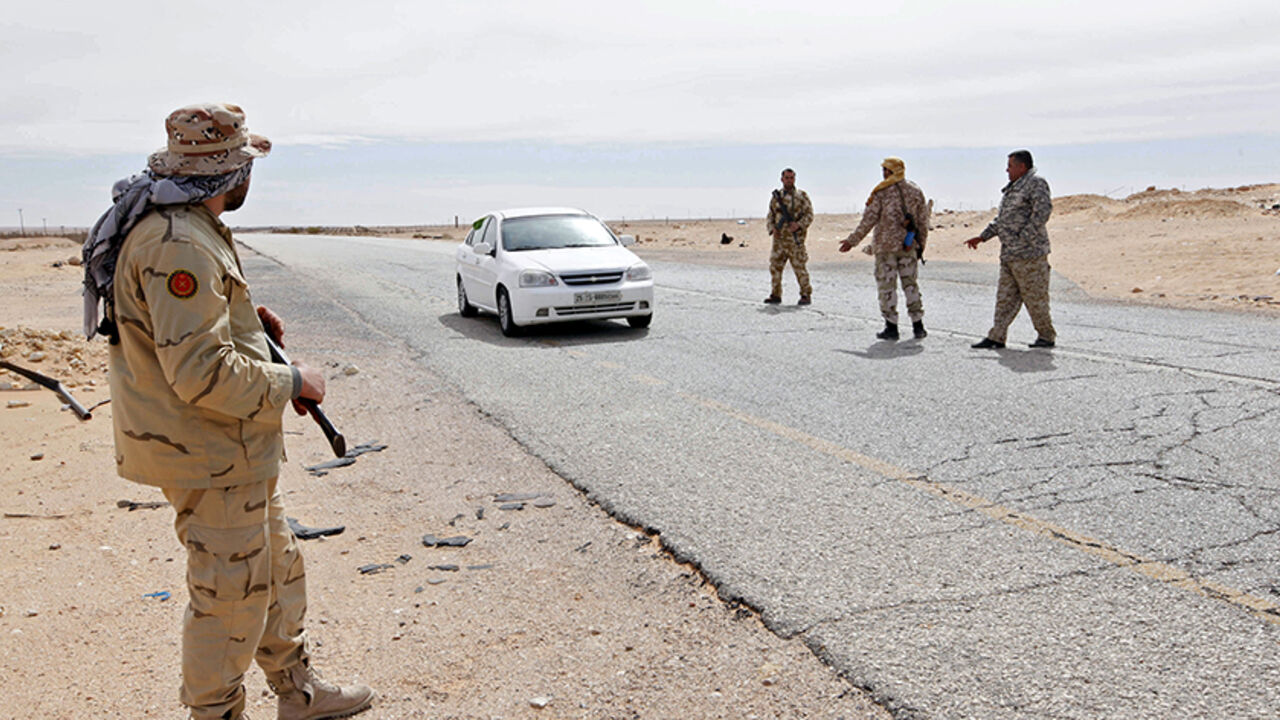 LIBYA-SECURITY/ Libyan soldiers manning a military outpost, stop a car at a checkpoint in Wadi Bey, west of the city of Sirte, which is held by Islamic State militants, February 23, 2016. REUTERS/Ismail Zitouny - RTX28A55