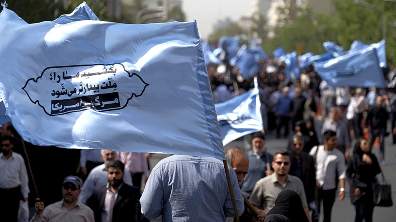 SAUDI-HAJ/IRAN Mourners attend the funeral of victims killed in Saudi Arabia during a stampede at the haj pilgrimage, in Tehran October 4, 2015. More than 464 Iranian nationals were killed in last month's crush in Mina, Saudi Arabia, Iran's Haj Organization says. Iranian officials have alleged the overall total death toll is more than 1,000. Saudi Arabia has confirmed the deaths of 769 people. The banner reads, "Kill our nation, our nation becomes more awake. Down with the U.S."REUTERS/Raheb Homavandi/TIMAATTENTION EDITOR