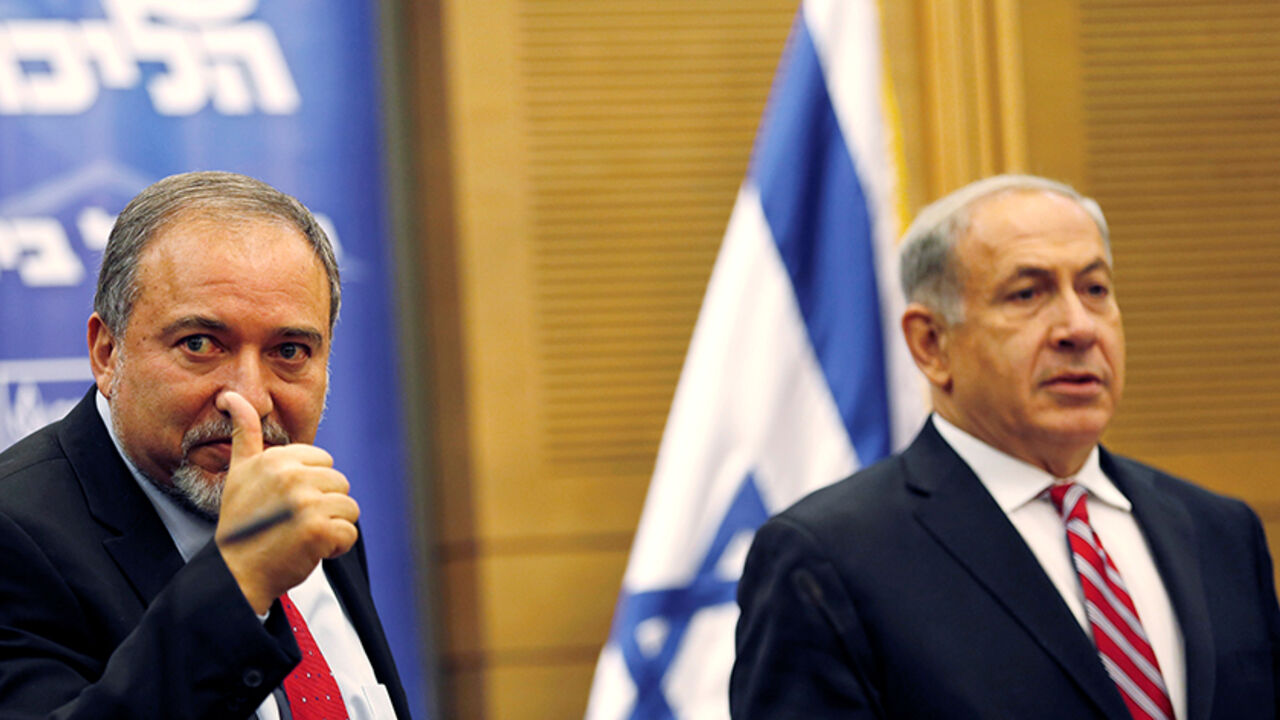 ISRAEL-POLITICS/ Israel's Prime Minister Benjamin Netanyahu (R) and Avigdor Lieberman attend a Likud-Beitenu faction meeting at the Knesset, the Israeli parliament, in Jerusalem November 11, 2013. REUTERS/Amir Cohen/File Photo - RTSFIT8