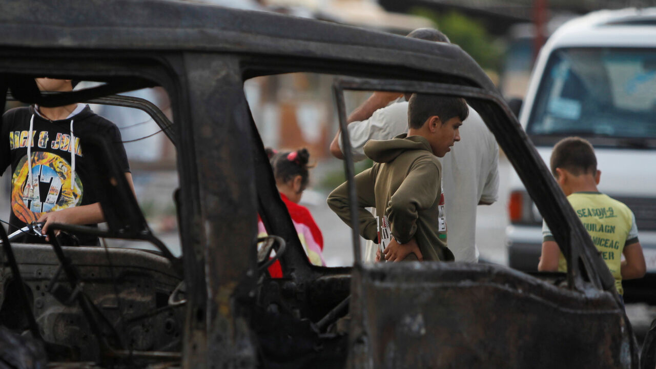 MIDEAST-CRISIS-SYRIA-LATAKIA Children inspect a damaged site after explosions hit a bus station in the Syrian city of Jableh May 23, 2016. REUTERS/Omar Sanadiki - RTSFL9Y