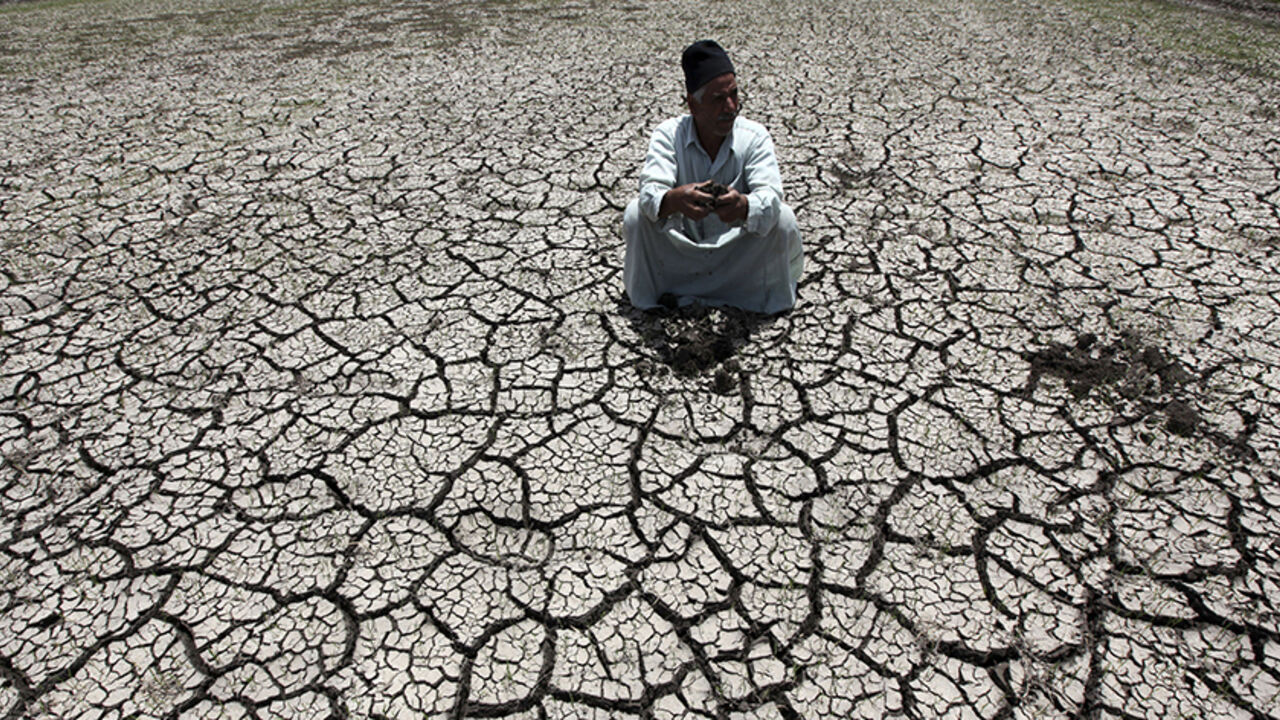EGYPT-ETHIOPIA/NILE An Egyptian farmer squats down on cracked soil to show the dryness of the land due to drought in a farm formerly irrigated by the river Nile, in Al-Dakahlya, about 120 km (75 miles) from Cairo June 4, 2013. Ethiopia has not thought hard enough about the impact of its ambitious dam project along the Nile, Egypt said on Sunday, underlining how countries down stream are concerned about its impact on water supplies. The Egyptian presidency was citing the findings of a report put together by a panel of experts f