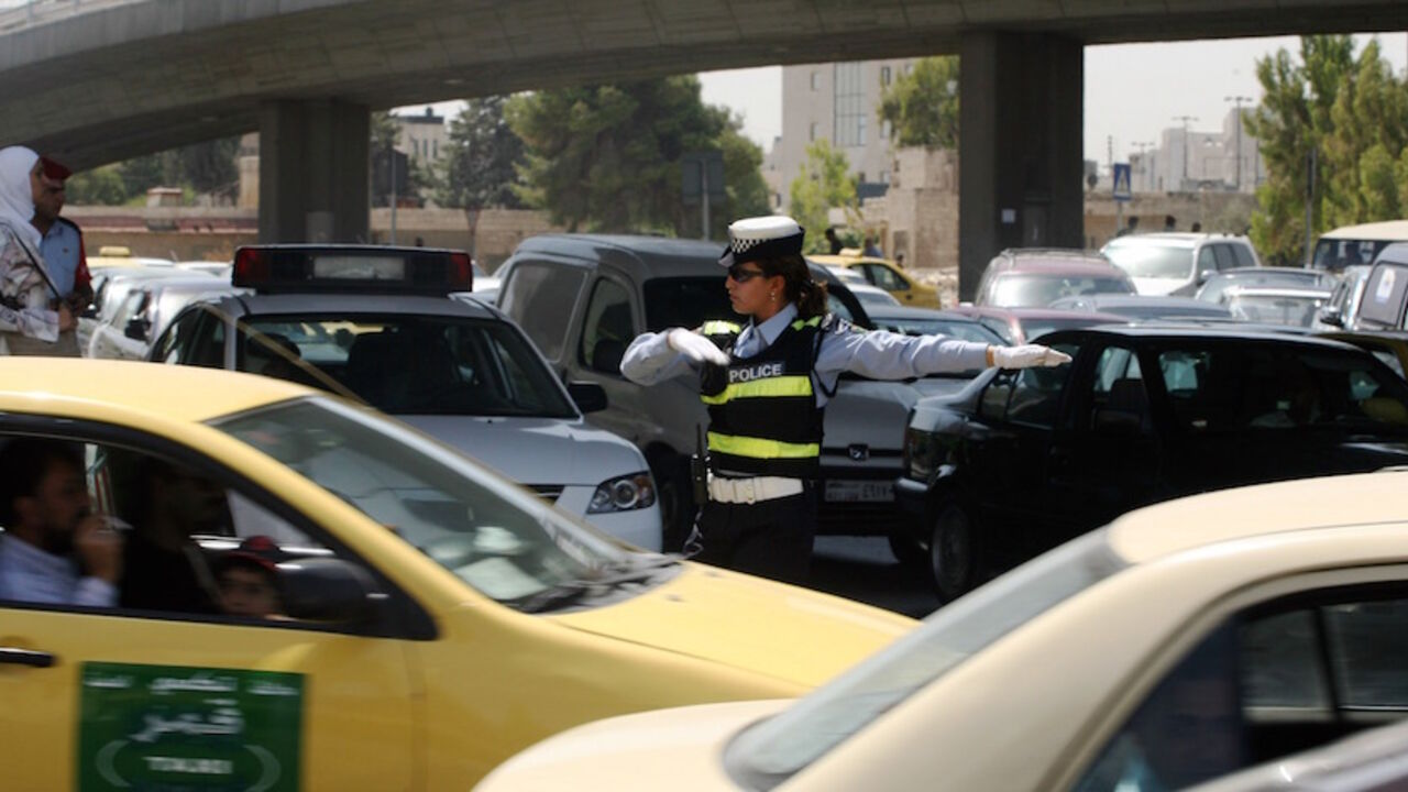 GYI0000690839.jpg AMMAN, JORDAN - SEPTEMBER 10: Jordanian traffic police officer Sylvia Hjazeen directs traffic at one of the city's most important road crossings on September 10, 2007 in Amman, Jordan. A women's police academy opened in Amman in 1972 making Jordan the first Arab country to admit women to its police services. There are currently 73 female officers in Amman traffic police, accounting for less than 5 percent of the service, and this year seven became the first women to patrol on motorcycles. (Photo by Salah Ma