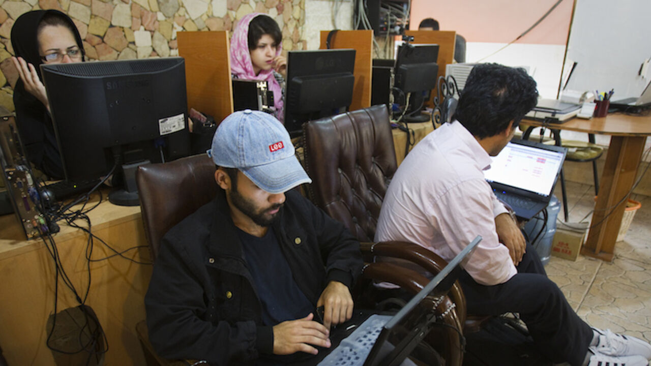 To match Feature IRAN-INTERNET/ Customers use computers at an internet cafe in Tehran May 9, 2011. Websites like Facebook, Twitter, YouTube and countless others were banned shortly after the re-election of Iran's President Mahmoud Ahmadinejad and the huge street protests that followed. Seen by the government as part of a "soft war" waged by the enemies of the Islamic Republic, social networking and picture sharing sites were a vital communication tool for the anti-Ahmadinejad opposition -- more than a year before they played a similar rol