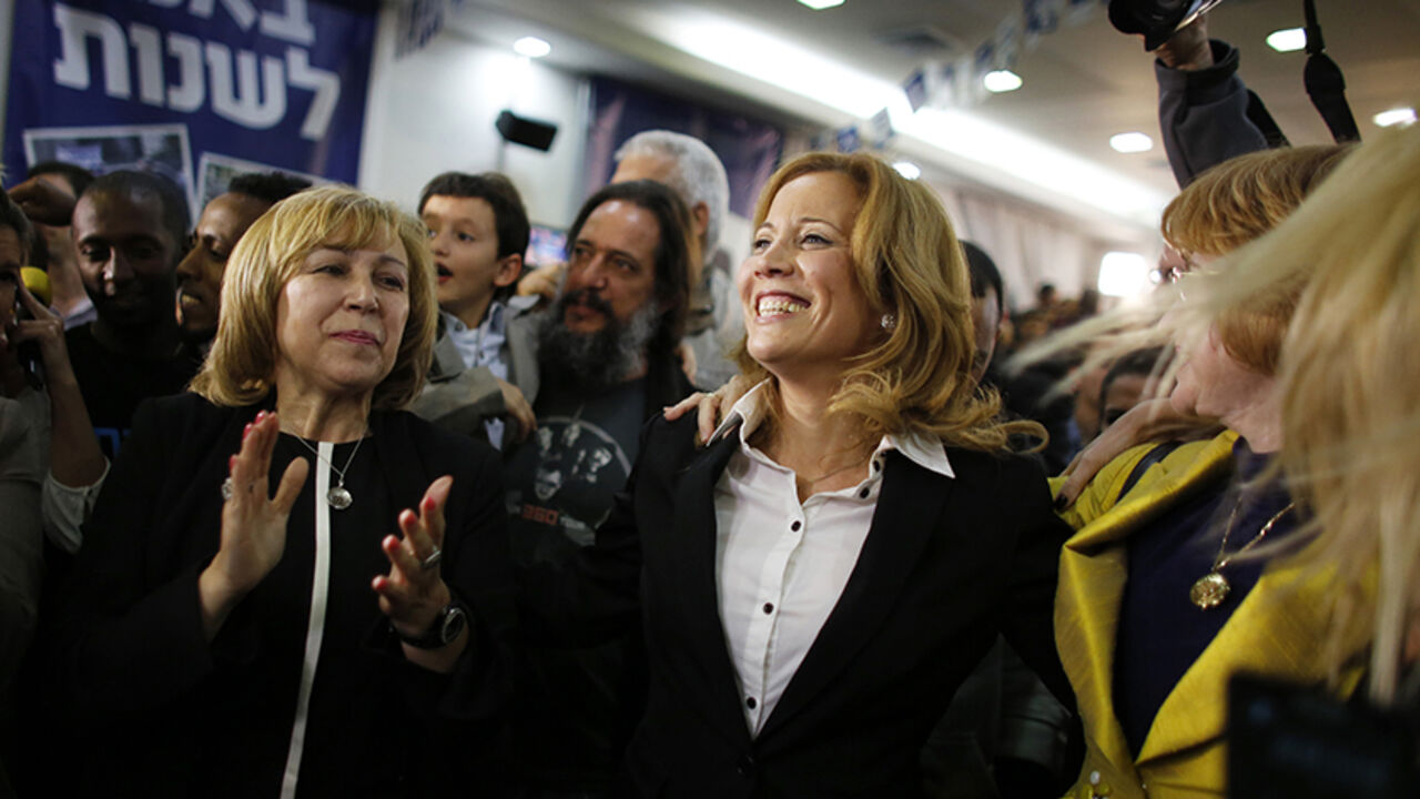 ISRAEL-ELECTION/NEWCOMERS Dr. Aliza Lavie (C), a Yesh Atid (There's a future) party candidate, celebrates exit poll results at the party's headquarters in Tel Aviv January 22, 2013. Israel's parliament, long heavy with retired generals, is getting a new look, with a freshman class that includes two youth protest leaders, an Ethiopian immigrant, a high tech millionaire and more women than ever. Thanks to the surprise second place finish of Yesh Atid, as well as the success of a new far-right group, the 120-member Knesset will have a