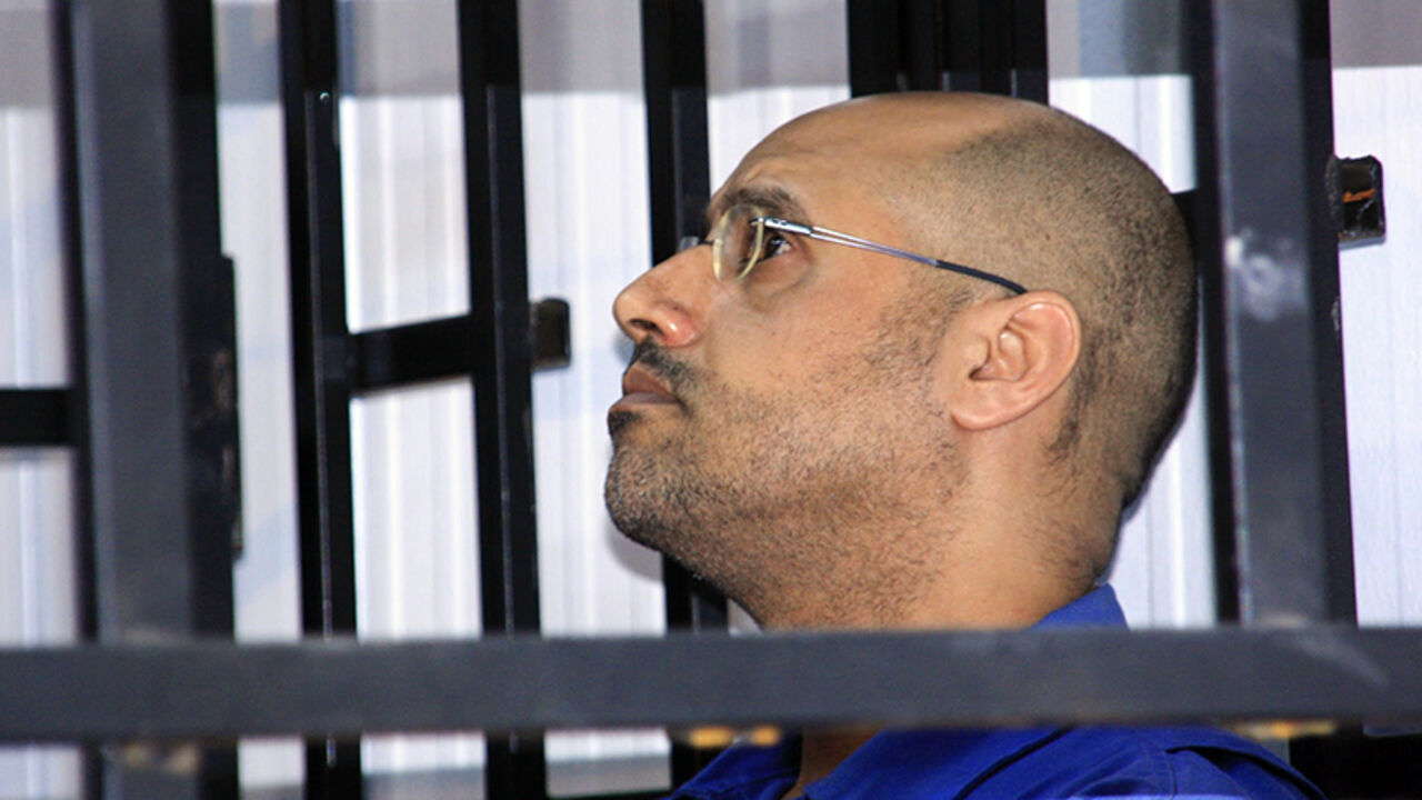 LIBYA/ Saif al-Islam Gaddafi, son of late Libyan leader Muammar Gaddafi, attends a hearing behind bars in a courtroom in Zintan May 25, 2014. REUTERS/Stringer (LIBYA - Tags: POLITICS CIVIL UNREST CRIME LAW) - RTR3QSD2