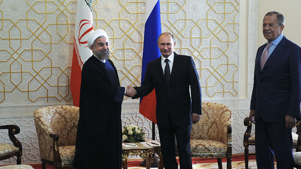 RUSSIA-IRAN/ (L-R) Iran's President Hassan Rouhani, Russia's President Vladimir Putin and Russia's Foreign Minister Sergei Lavrov pose for a picture before their meeting at the Shanghai Cooperation Organization (SCO) summit in Dushanbe September 12, 2014. REUTERS/Mikhail Klimentyev/RIA Novosti/Kremlin (TAJIKISTAN - Tags: POLITICS) THIS IMAGE HAS BEEN SUPPLIED BY A THIRD PARTY. IT IS DISTRIBUTED, EXACTLY AS RECEIVED BY REUTERS, AS A SERVICE TO CLIENTS - RTR45ZQI