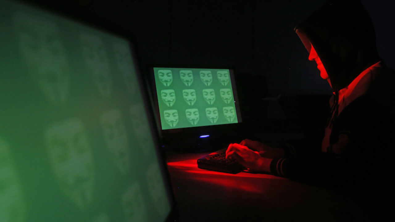 HACKING-TOOL/ Man poses in front of on a display showing the word 'cyber' in binary code, in this picture illustration taken in Zenica December 27, 2014. A previously undisclosed hacking campaign against military targets in Israel and Europe is probably backed by a country that misused security-testing software to cover its tracks and enhance its capability, researchers said. Picture taken December 27, 2014. REUTERS/Dado Ruvic (BOSNIA AND HERZEGOVINA - Tags: SCIENCE TECHNOLOGY CRIME LAW TPX IMAGES OF THE DAY) - RTR4JEYI