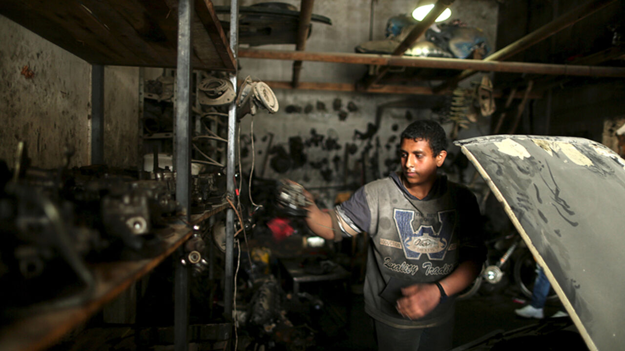 PALESTINIANS-GAZA/CHILD-LABOUR Palestinian boy Mohamoud Yazji, 16, who works as apprentice mechanic, repairs a car at a garage in Gaza City March 17, 2016. Yazji, whose father works as a tailor, earns 50 Shekels ($12.9) a week to help his father support their family. The boy, who quit school, hopes to own a garage in the future. REUTERS/Mohammed Salem SEARCH "SALEM LABOUR" FOR THIS STORY. SEARCH "THE WIDER IMAGE" FOR ALL STORIES - RTSCT76