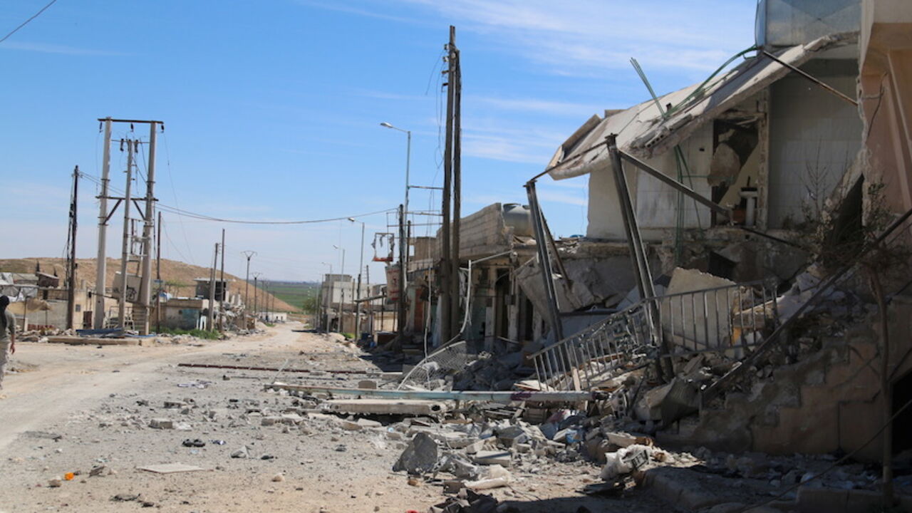 MIDEAST-CRISIS/SYRIA-ALEPPO A man walks near damaged houses after Syrian rebels and the al Qaeda-affiliated Nusra Front took control of al-'Iss town, in Aleppo countryside, Syria April 2, 2016. REUTERS/Ammar Abdullah - RTSDAHL