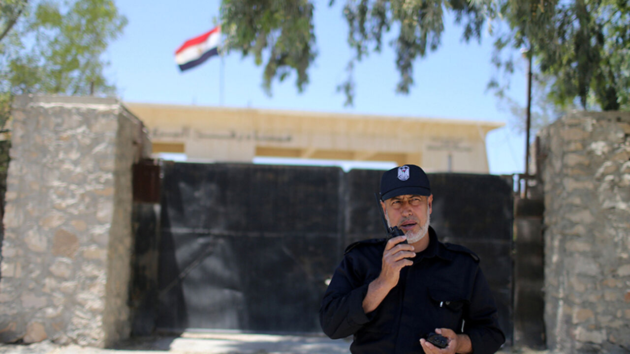 PALESTINIANS-GAZA/TRAP A member of the Palestinian security forces loyal to Hamas speaks on a walkie-talkie at Rafah border crossing between Egypt and southern Gaza Strip May 19, 2016. REUTERS/Ibraheem Abu Mustafa - RTSEZZG