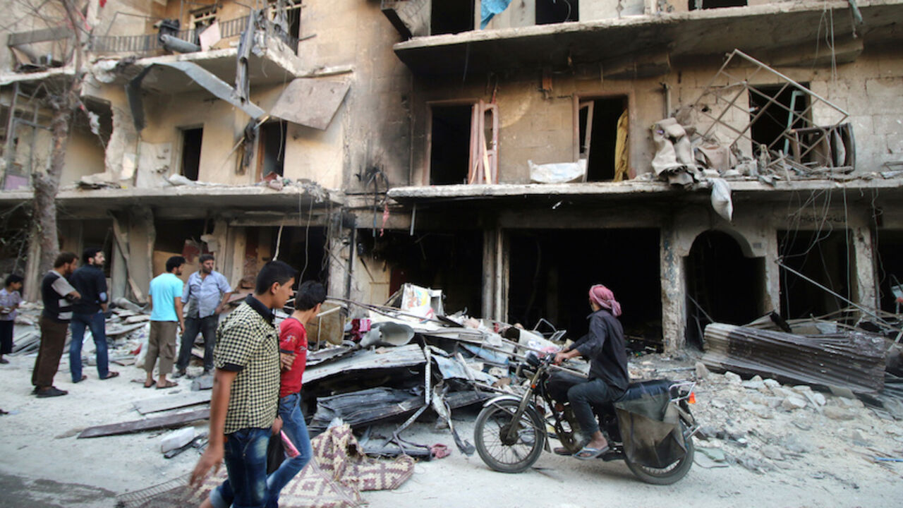 MIDEAST-CRISIS/SYRIA Men inspect damage after an air strike on Aleppo's rebel-held al-Shaar neighbourhood, Syria June 8, 2016. REUTERS/Abdalrhman Ismail - RTSGM5D