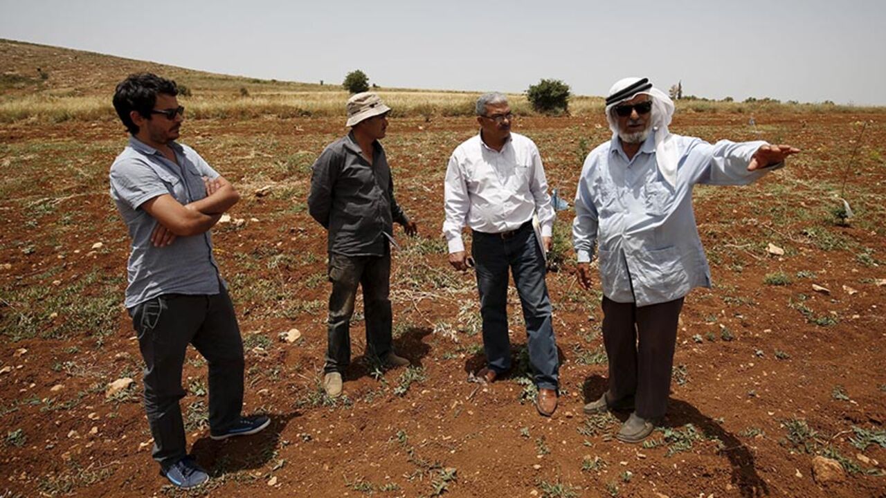 ISRAEL-RIGHTS/ B'Tselem field researcher Iyad Hadad (2nd R) listens to a testimony from a Palestinian farmer, who said his land was damaged in an attack by Israeli settlers, in the West Bank village of Turmus Aya near Ramallah June 8, 2015. B'Tselem is an Israeli NGO that has long been a bane of the government, tirelessly flagging human rights abuses by Israel's military in the Palestinian territories. Set up by a group of academics, lawyers, journalists and politicians more than 25 years ago, the organisation - whose nam