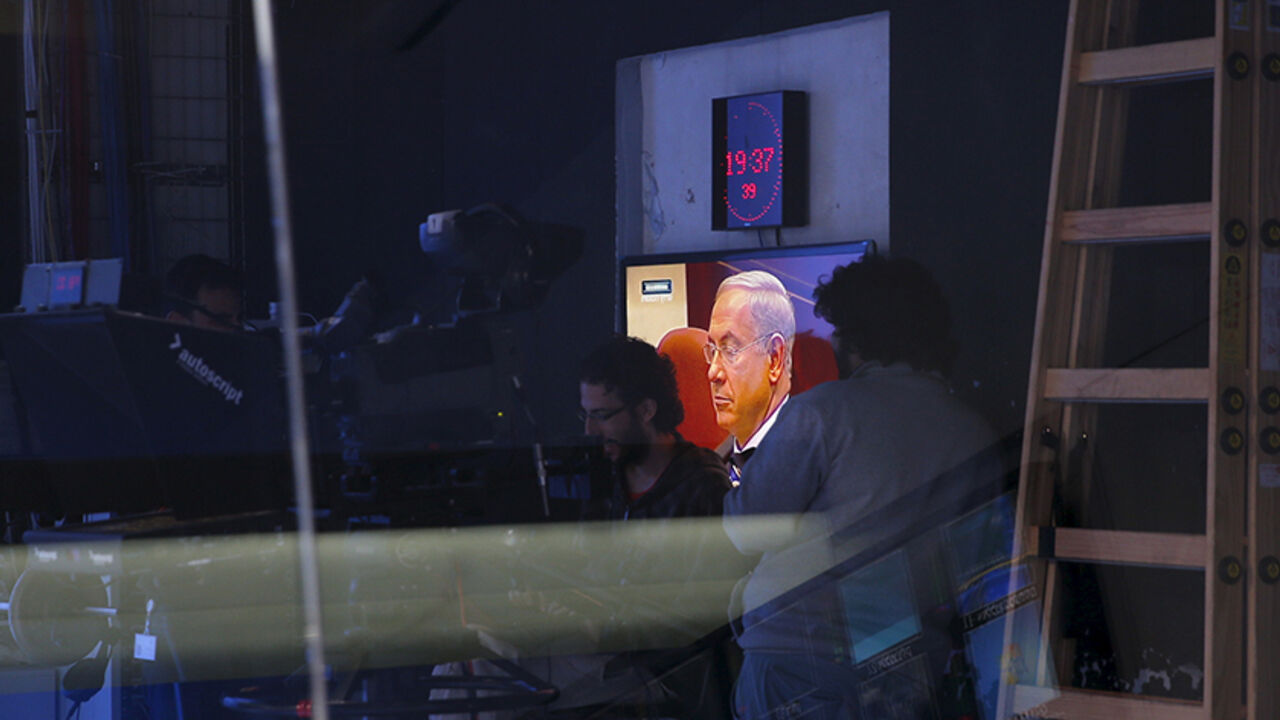 ISRAEL-NETANYAHU/MEDIA Israel's Prime Minister Benjamin Netanyahu is seen on a monitor before the evening news bulletin at Channel 10 in Jerusalem November 18, 2015. Critics say Netanyahu, known as "Bibi," is hitting the wrong note when it comes to the media, weakening press freedom and holding sway over TV broadcasters in a country that bills itself as the Middle East's only true democracy. Picture taken November 18, 2015. To match Insight ISRAEL-NETANYAHU/MEDIA REUTERS/Ronen Zvulun - RTX1VG4V