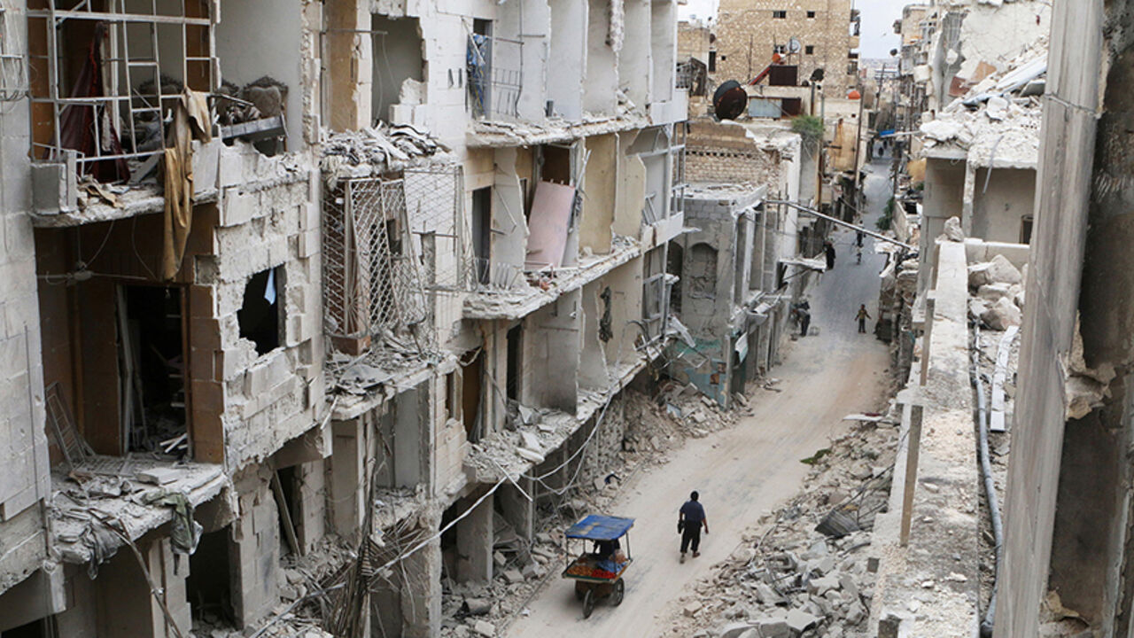 MIDEAST-CRISIS/SYRIA-ALEPPO Residents walk near damaged buildings in the rebel held area of Old Aleppo, Syria May 5, 2016. REUTERS/Abdalrhman Ismail/File Photo - RTX2FSH5