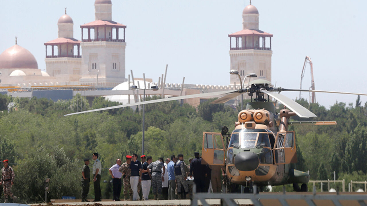 MIDEAST-CRISIS/JORDAN-SYRIA/ A security member, who was injured during an attack at a camp for Syrian refugees in eastern Jordan near the borders of Iraq, Syria and Jordan, is transported from a military helicopter to al-Hussein Medical Centre in Amman, Jordan, June 21, 2016. REUTERS/Stringer - RTX2HCMY