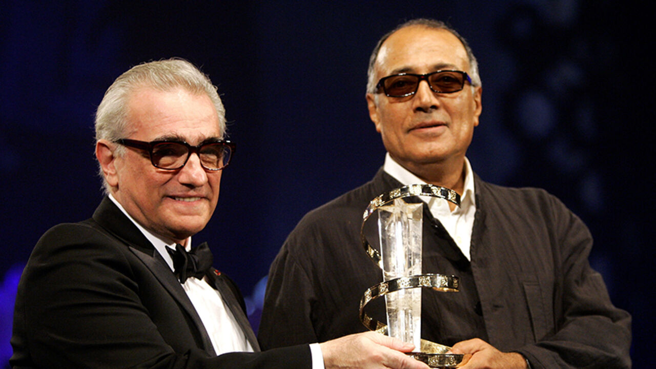 PEOPLE-ABBASKIAROSTAMI/ Iranian director Abbas Kiarostami (R) receives an award from U.S. director Martin Scorsese during the closing ceremony of the 5th Marrakesh International Film Festival in Marrakesh, Morocco, November 19, 2005. REUTERS/Andrea Comas/File Photo - RTX2JPDJ