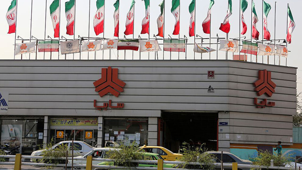 IRAN ECONOMY AUTO INTERNET TO GO WITH AFP STORY BY ALI NOORANI - A picture taken on September 12, 2015 shows cars driving past a sales office of Iranian auto manufacturer SAIPA group in the capital Tehran. A campaign to boycott "substandard and expensive" Iranian-made cars has fired up social media in the Islamic republic, where its supporters have been accused of anti-revolutionary treason. AFP PHOTO / ATTA KENARE (Photo credit should read ATTA KENARE/AFP/Getty Images)