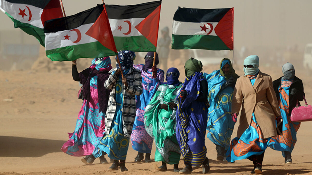 AFP_8A7CA Sahrawi women hold Polisario Front's flags during a ceremony to mark 40 years after the Front proclaimed the Sahrawi Arab Democratic Republic (SADR) in the disputed territory of Western Sahara on February 27, 2016 at the Sahrawi refugee camp of Dakhla which lies 170 km to the southeast of the Algerian city of Tindouf.
SADR was declared in 1976 by the Polisario Front -- a rebel movement that wants independence for Western Sahara -- which fought a guerrilla war against Rabat's forces before a ceasefire in 19
