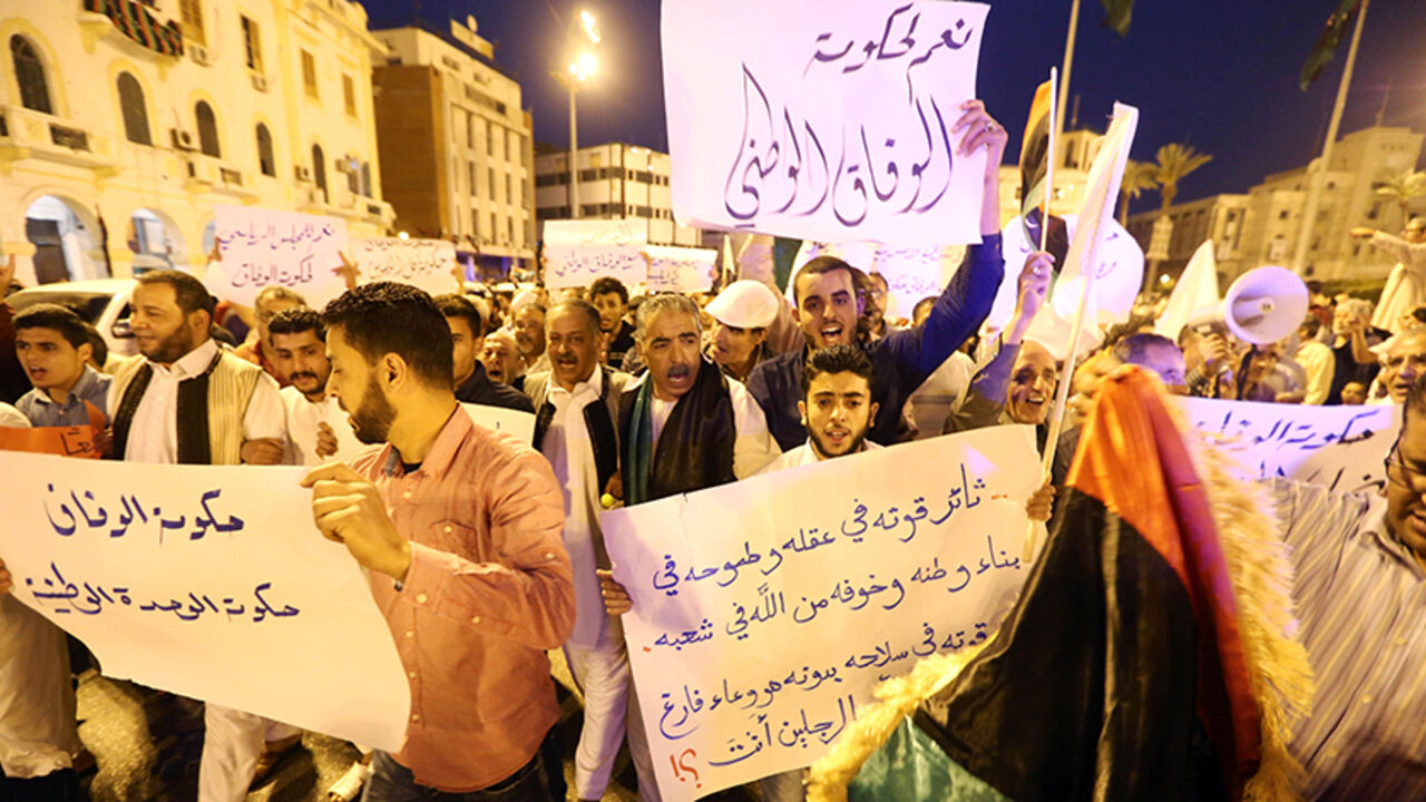 AFP_9A297 Pro-UN-backed government protesters hold placards and shout slogans during a demonstration in the Libyan capital Tripoli on April 1, 2016.
Hundreds of supporters of the Government of National Accord (GNA) rallied in the capital where the unity cabinet is striving to exert its authority, calling on a rival administration to depart. / AFP / MAHMUD TURKIA (Photo credit should read MAHMUD TURKIA/AFP/Getty Images)