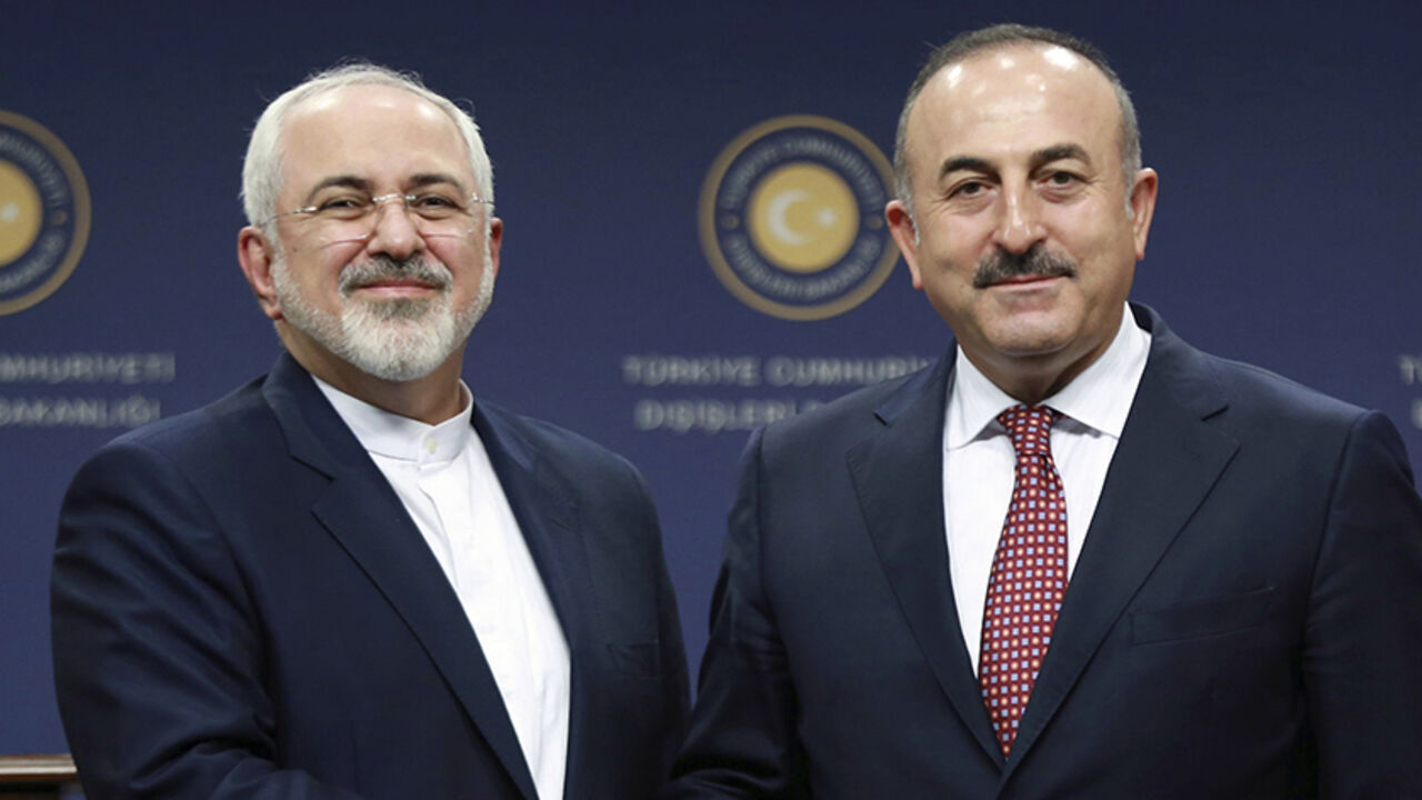 AFP_EJ3BN Turkish Foreign Minister Mevlut Cavusoglu (R) and Iran's Foreign Minister Mohammad Javad Zarif shake hands following a joint press conference at the Foreign Ministry in Ankara on August 12, 2016. / AFP / ADEM ALTAN (Photo credit should read ADEM ALTAN/AFP/Getty Images)