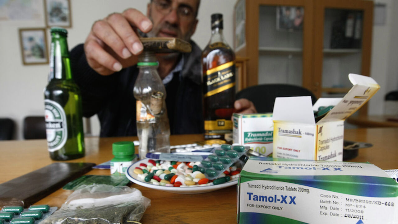 TO GO WITH AFP STORY BY ADEL ZAANOUN A H TO GO WITH AFP STORY BY ADEL ZAANOUN A Hamas police officer shows confiscated drugs, alcohol and medication at a police station in the northern Gaza Strip town of Jabalia on November 4, 2009. Drug use was once rare in Gaza's conservative society, but addiction experts say prescription painkillers and marijuana have become more common since Israel and Egypt sealed off the territory to all but basic goods in the wake of the Islamist Hamas movement's bloody takeover in June 2007. AFP PHOTO/MOHAMMED ABED (Phot