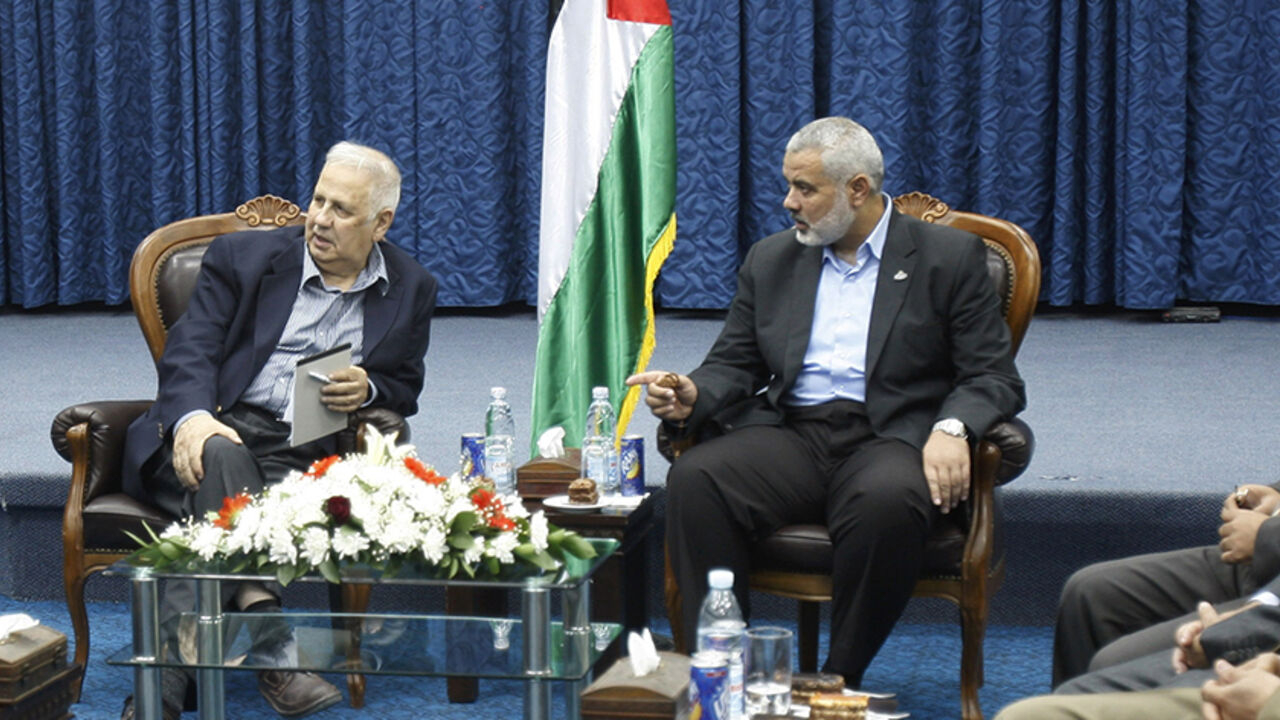 PALESTINIANS-FACTIONS/UNITY Hamas prime minister in Gaza Ismail Haniyeh (R) gestures during a meeting with Hanna Nasir (L), chairman of the Palestinian Central Election Commission (CEC), and the commission members in Gaza City May 28, 2012. Palestinian President Mahmoud Abbas's Fatah faction and Palestinian Islamist group Hamas began talks to form a unity government on Monday in a renewed bid to heal political rifts, paving the way for a general election. REUTERS/ Ibraheem Abu Mustafa (GAZA - Tags: POLITICS) - RTR32QWC