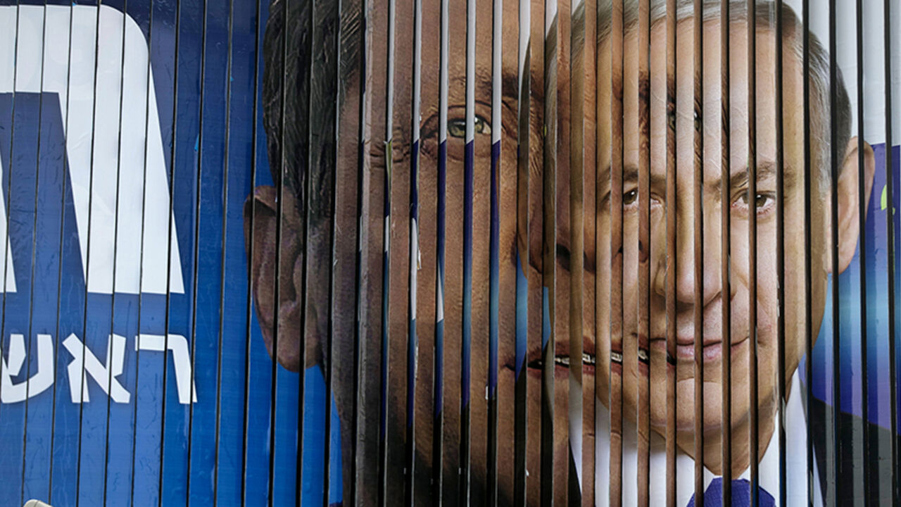 ISRAEL-ELECTION/ Israel's Prime Minister Benjamin Netanyahu (R) and Isaac Herzog, Co-leader of the centre-left Zionist Union, are pictured together as campaign billboards rotate in Tel Aviv, March 9, 2015. Israelis will vote in a parliamentary election on March 17, choosing among party lists of candidates to serve in the 120-seat Knesset. Currently, polls show Netanyahu's Likud party and the centre-left Zionist Union opposition running neck-and-neck, with each predicted to win around 24 seats in the Knesset.
REUTERS/Baz Ra