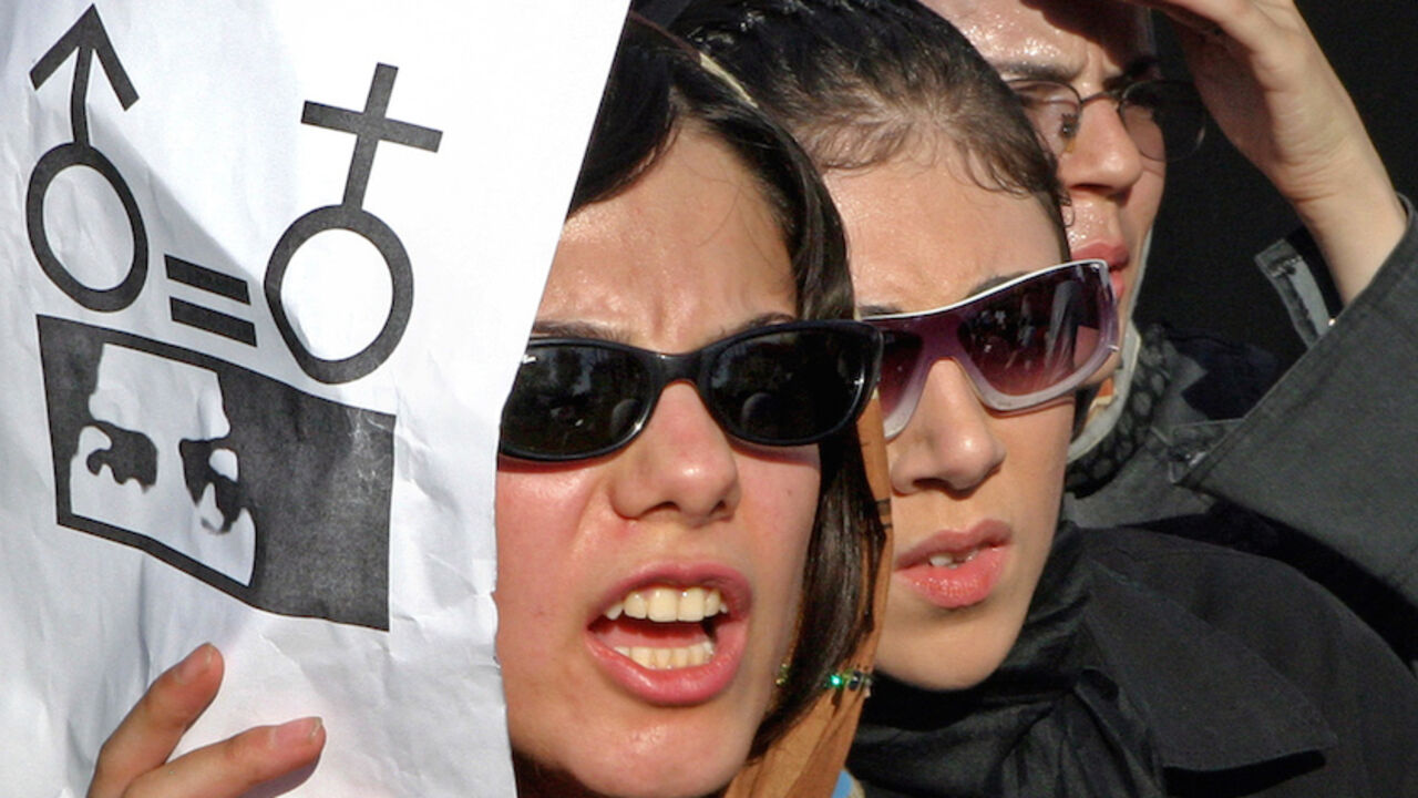 Iranian women take part in a protest in Tehran. Iranian women take part in a protest in front of the Tehran University in Tehran June 12, 2005. About 300 women took part in the protest against gender discrimination in the Islamic republic of Iran. REUTERS/Raheb Homavandi PJH - RTRE6DE