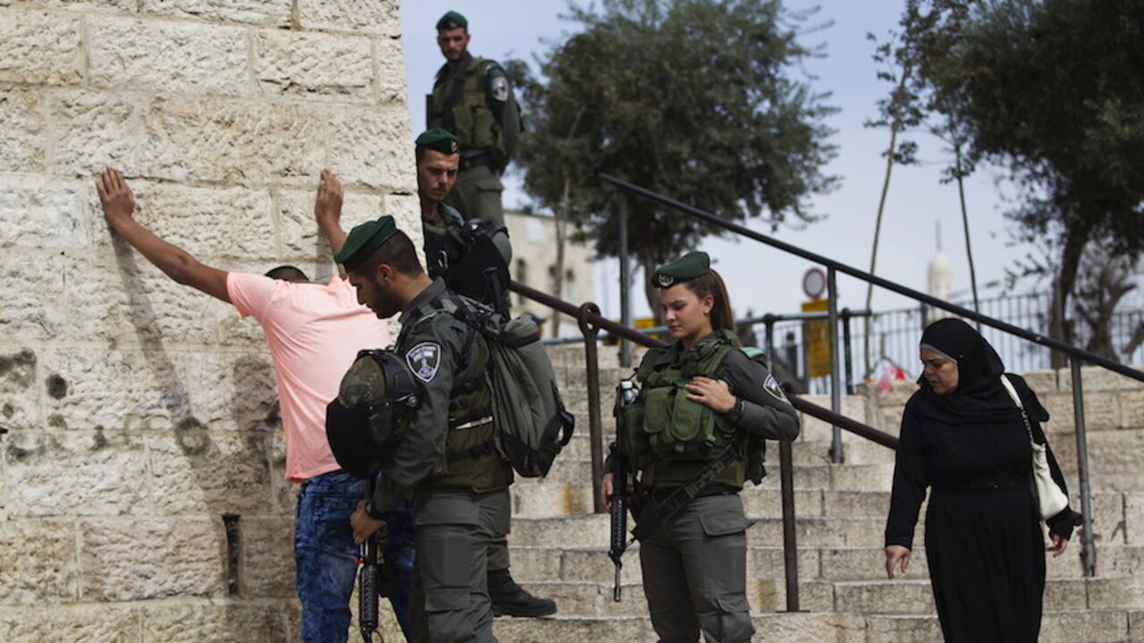 Israeli border policemen perform a security check on a Palestinian youth at Damascus Gate just outside Jerusalem's Old City Israeli border policemen perform a security check on a Palestinian youth at Damascus Gate just outside Jerusalem's Old City before Friday prayers October 23, 2015. Palestinian factions called for mass rallies against Israel in the occupied West Bank and East Jerusalem in a "day of rage" on Friday, as world and regional powers pressed on with talks to try to end more than three weeks of bloodshed. Israeli authorities also lifted restrictions on Friday that had banned men aged under 40 from using the flashpoi