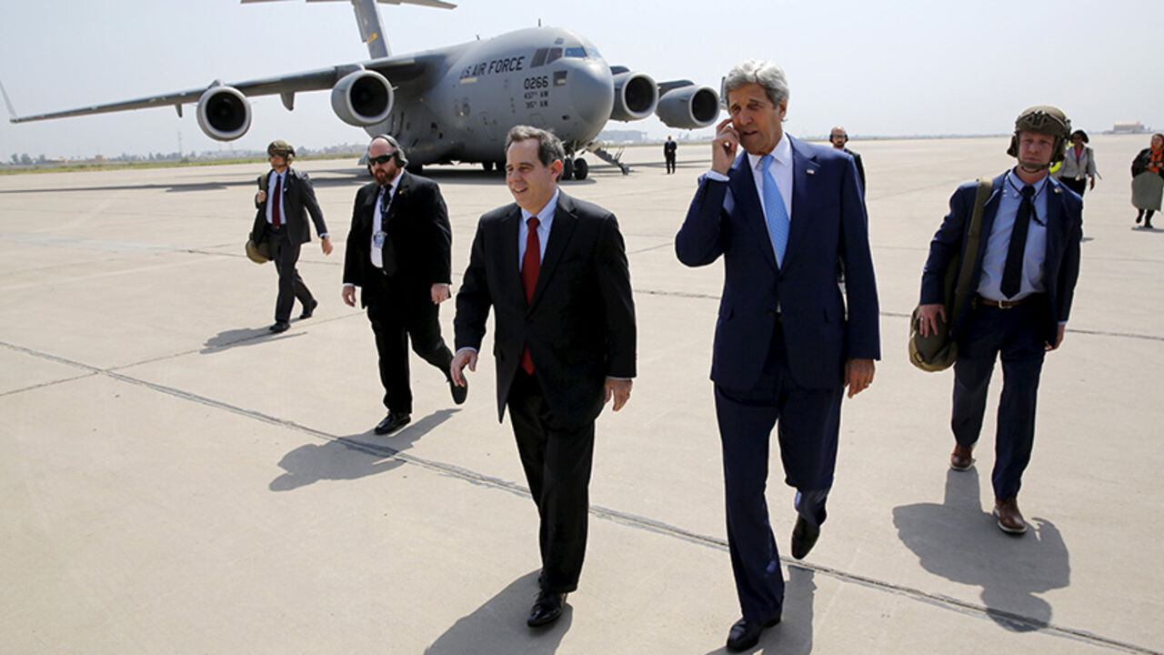 MIDEAST-CRISIS/IRAQ-USA U.S. Ambassador to Iraq Stuart Jones (center L) walks with Secretary of State John Kerry (center R) as he arrives via military transport at Baghdad International Airport in Baghdad April 8, 2016. REUTERS/Jonathan Ernst TPX IMAGES OF THE DAY - RTSE4QI
