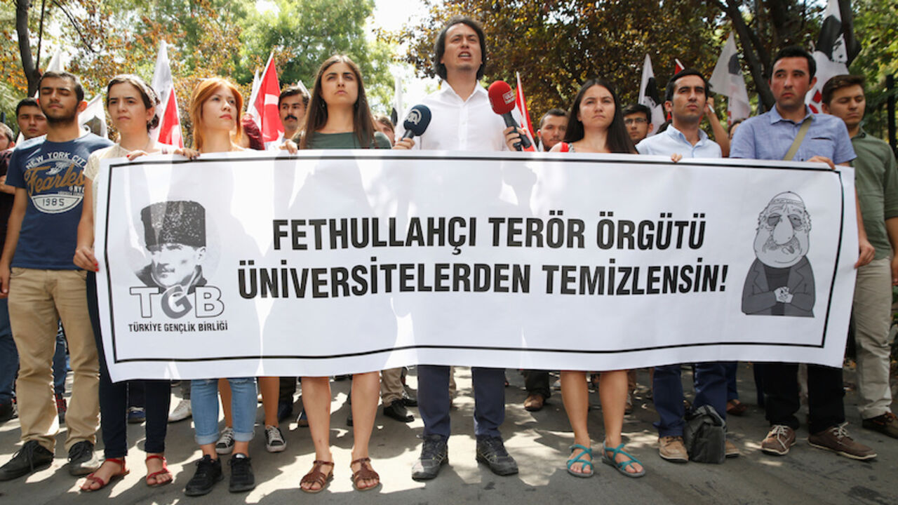 TURKEY-SECURITY/ Members of the ultra-nationalist Turkish Youth Association (TGB) take part in a protest against academics close to U.S.-based cleric Fethullah Gulen in front of Ankara University in Ankara, Turkey, July 21, 2016. The banner reads "Universities should be cleansed from Fethullah's terrorist organisation". REUTERS/Baz Ratner - RTSJ0KC