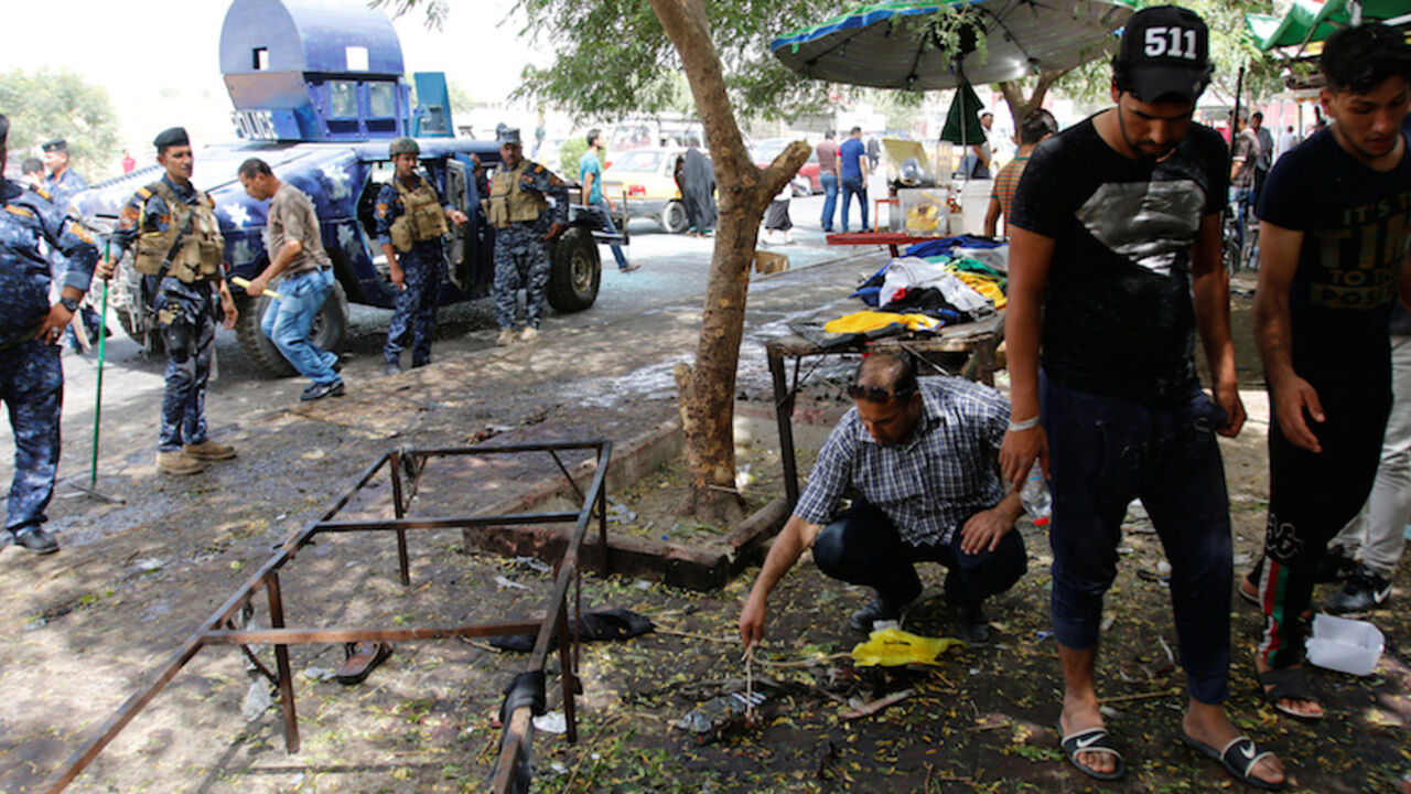 Residents and Iraqi security forces inspect the site where a suicide bomber detonated his explosive vest at the entrance to Kadhimiya, a mostly Shi'ite Muslim district in northwest Baghdad Residents and Iraqi security forces inspect the site where a suicide bomber detonated his explosive vest at the entrance to Kadhimiya, a mostly Shi'ite Muslim district in northwest Baghdad, Iraq July 24, 2016. REUTERS/Khalid al Mousily - RTSJDJ7